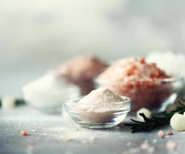 mix-of-different-salt-types-on-grey-concrete-backg-2024-10-16-06-26-32-utc-min